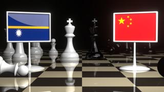 Nauru National Flag, The national flag on a chessboard with the Japanese flag in the background