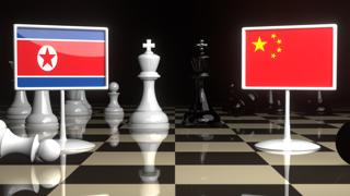 North-Korea National Flag, The national flag on a chessboard with the Japanese flag in the background