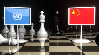 UN National Flag, The national flag on a chessboard with the Japanese flag in the background