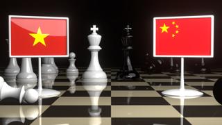 Vietnam National Flag, The national flag on a chessboard with the Japanese flag in the background