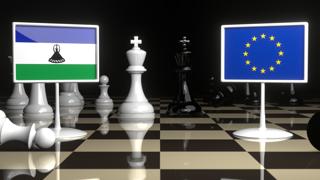 Lesotho National Flag, Flags placed on a chessboard with the EU flag in the background