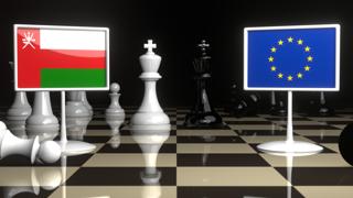 Oman National Flag, Flags placed on a chessboard with the EU flag in the background