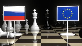 Russia National Flag, Flags placed on a chessboard with the EU flag in the background