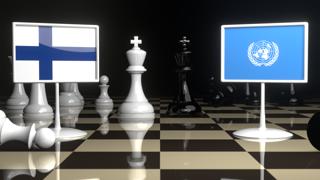 Finland National Flag, Flags placed on a chessboard with the UN flag in the background