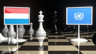 Luxembourg National Flag, Flags placed on a chessboard with the UN flag in the background