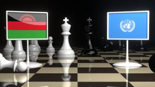 Malawi National Flag, Flags placed on a chessboard with the UN flag in the background