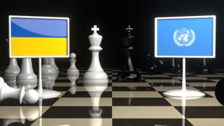 Ukraine National Flag, Flags placed on a chessboard with the UN flag in the background