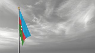 Azerbaijan National Flag, The national flag and flagpole visible from afar against a black and white sky background