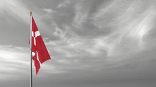 Denmark National Flag, The national flag and flagpole visible from afar against a black and white sky background