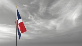 Dominican-Republic National Flag, The national flag and flagpole visible from afar against a black and white sky background