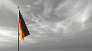 Germany National Flag, The national flag and flagpole visible from afar against a black and white sky background