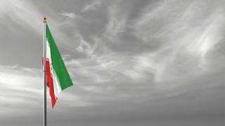 Iran National Flag, The national flag and flagpole visible from afar against a black and white sky background