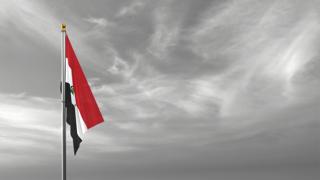 Iraq National Flag, The national flag and flagpole visible from afar against a black and white sky background