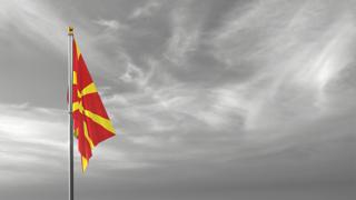 North-Macedonia National Flag, The national flag and flagpole visible from afar against a black and white sky background