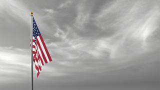 USA National Flag, The national flag and flagpole visible from afar against a black and white sky background