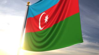 Azerbaijan National Flag, A fluttering flag and flagpole seen up close against a dark blue sky