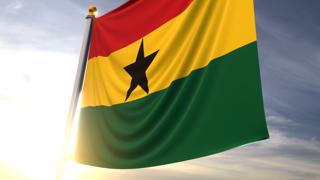 Ghana National Flag, A fluttering flag and flagpole seen up close against a dark blue sky