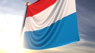 Luxembourg National Flag, A fluttering flag and flagpole seen up close against a dark blue sky