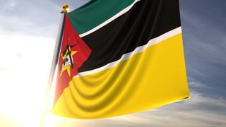 Mozambique National Flag, A fluttering flag and flagpole seen up close against a dark blue sky