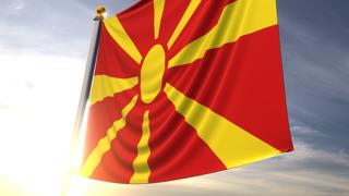 North-Macedonia National Flag, A fluttering flag and flagpole seen up close against a dark blue sky