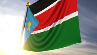 South-Sudan National Flag, A fluttering flag and flagpole seen up close against a dark blue sky