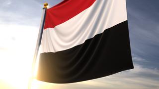 Yemen National Flag, A fluttering flag and flagpole seen up close against a dark blue sky