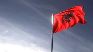 Albania National Flag, The national flag and flagpole looking up against a dark blue sky