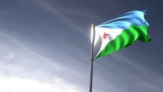 Djibouti National Flag, The national flag and flagpole looking up against a dark blue sky