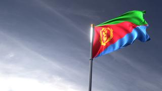 Eritrea National Flag, The national flag and flagpole looking up against a dark blue sky