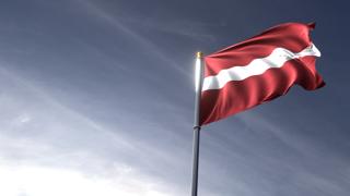 Latvia National Flag, The national flag and flagpole looking up against a dark blue sky