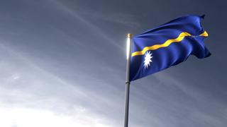 Nauru National Flag, The national flag and flagpole looking up against a dark blue sky