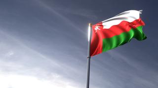 Oman National Flag, The national flag and flagpole looking up against a dark blue sky