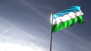 Uzbekistan National Flag, The national flag and flagpole looking up against a dark blue sky