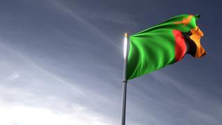 Zambia National Flag, The national flag and flagpole looking up against a dark blue sky