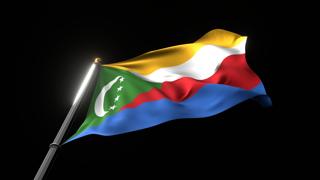 Comoros National Flag, A fluttering national flag and flagpole viewed from below on a black background