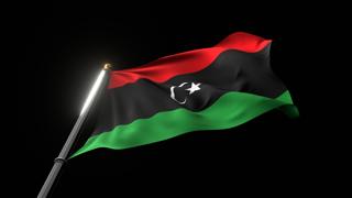 Libya National Flag, A fluttering national flag and flagpole viewed from below on a black background