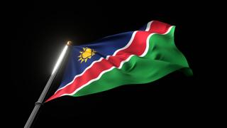 Namibia National Flag, A fluttering national flag and flagpole viewed from below on a black background